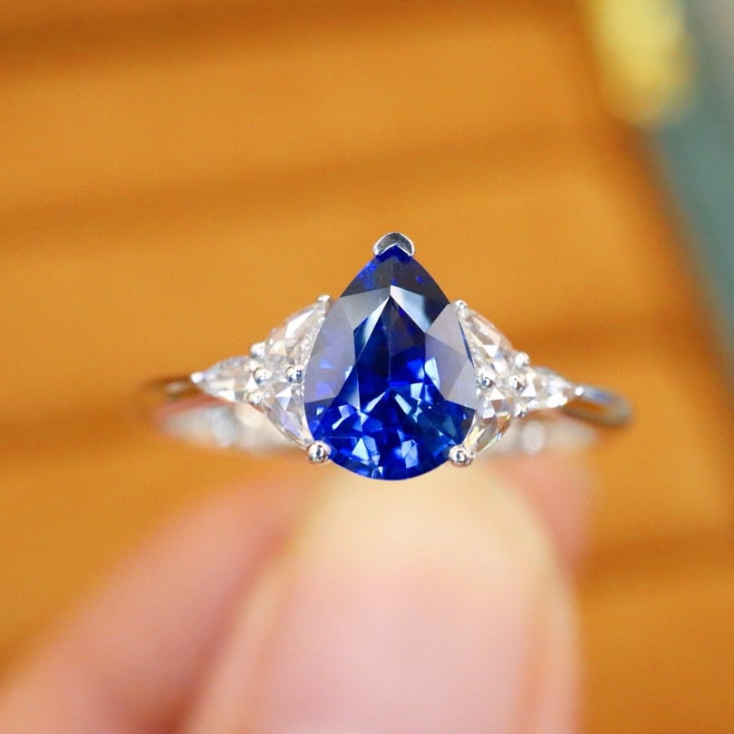 14k Gold 1.22 Ctw Natural Sapphire & Diamond Ring: Ref:230980241 // gold content:14k gold // ring size:7. 25us // // main gemstone:sapphire // shape:pear // carat weight:1. 10ct // color:royal blue // treatment:natural // // adjacent gemstone 2 :