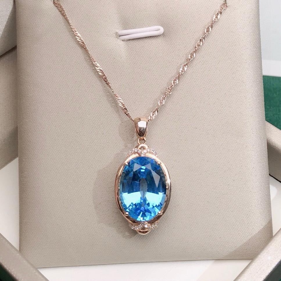 14k Gold 9.75 Ctw Natural Topaz & Diamond Pendant( Without Chain ): Ref:231151224 // gold content:14k gold // main gemstone:topaz // shape:oval // carat weight:9. 7ct // color:blue // treatment:natural // // adjacent gemstone 2 : diamond // number of stones:18 //