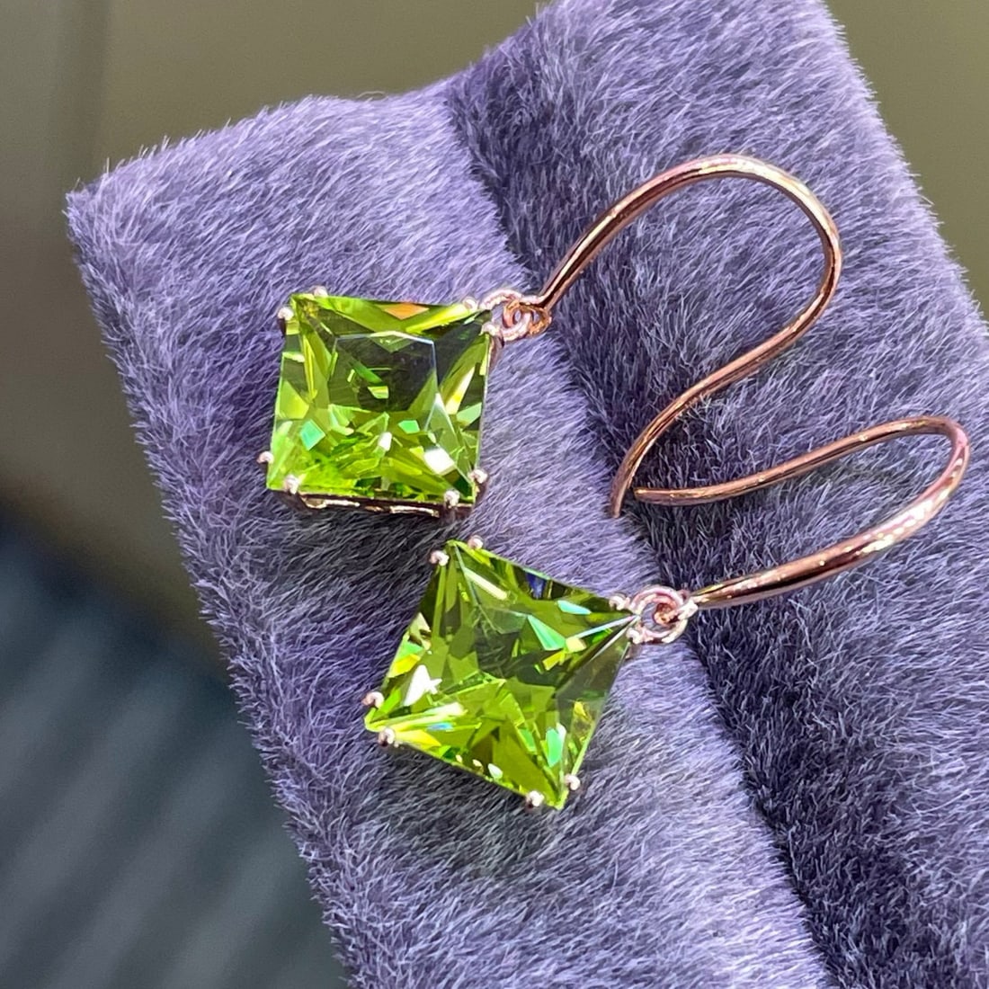 14k Gold 5.25 Ct Natural Peridot Earrings: Ref:230990052 // gold content:14k gold // main gemstone:peridot // shape:princess // carat weight:5. 25ct // color:green // treatment:natural // Condition: New High Estimate: 2500 Low Estimate: 1700