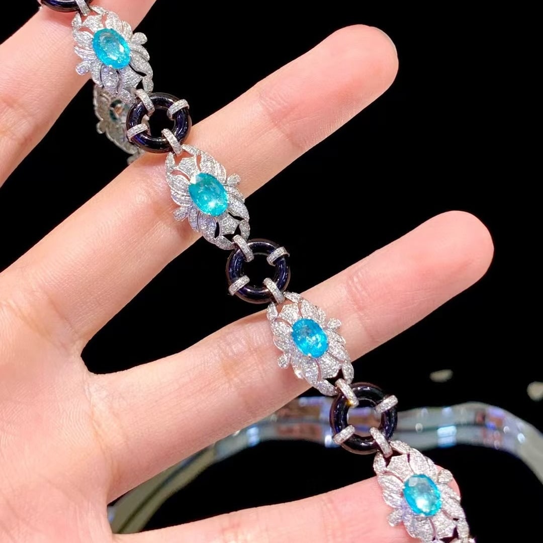 14k Gold 5.2 Ct Natural Paraiba Tourmaline & Diamond Bracelet: Ref:230990126 // gold content:14k gold // main gemstone:paraiba tourmaline // shape:oval // carat weight:5. 2ct // color:neon blue // treatment:natural // // adjacent gemstone 2 : diamond // number