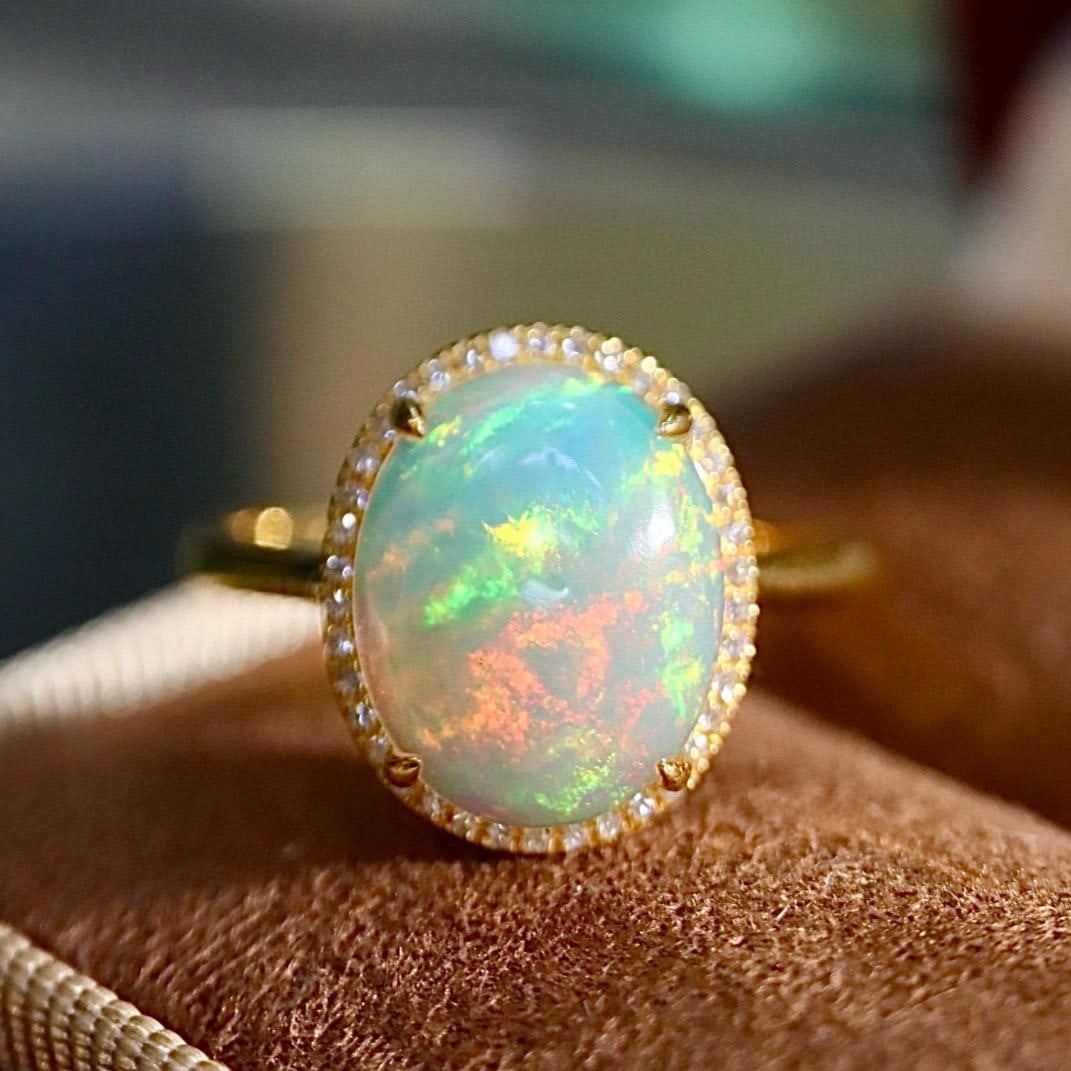 14k Gold 2.21 Ctw Natural Opal & Diamond Ring: Ref:231157084 // gold content:14k gold // ring size:7. 25us // // main gemstone:opal // shape:oval // carat weight:2. 1ct // color:color // treatment:natural // // adjacent gemstone 2 : diamond //