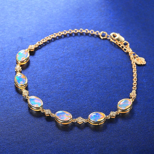 14k Gold 2.70 Ctw Natural Opal & Diamond Bracelet: Ref:231157085 // gold content:14k gold // main gemstone:opal // shape:oval // carat weight:2. 62ct // color:color // treatment:natural // // adjacent gemstone 2 : diamond // number of stones:28 //