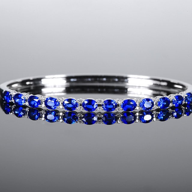 14k Gold 4.67 Ctw Natural Sapphire & Diamond Bangle: Ref:231153222 // gold content:14k gold // main gemstone:sapphire // shape:oval // carat weight:4. 41ct // color:blue // treatment:natural // // adjacent gemstone 2 : diamond // number of stones:26 // 