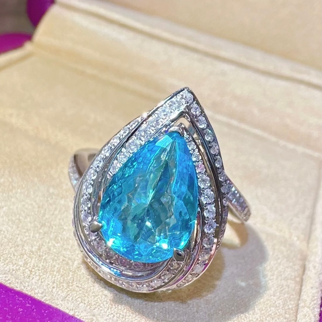 14k Gold 2.94 Ctw Natural Paraiba Tourmaline & Diamond Ring: Ref:231162419 // gold content:14k gold // ring size:7. 25us // // main gemstone:paraiba tourmaline // shape:pear // carat weight:2. 49ct // color:neon blue // treatment:natural // // adjacent