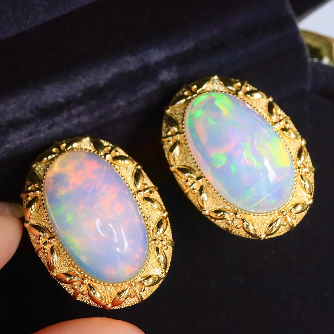 14k Gold 12.16 Ct Natural Opal Earrings: Ref:231165181 // gold content:14k gold // main gemstone:opal // shape:oval // carat weight:12. 16ct // color:color // treatment:natural // Condition: New Low Estimate: 10000.00 High Estimate: 16000.00