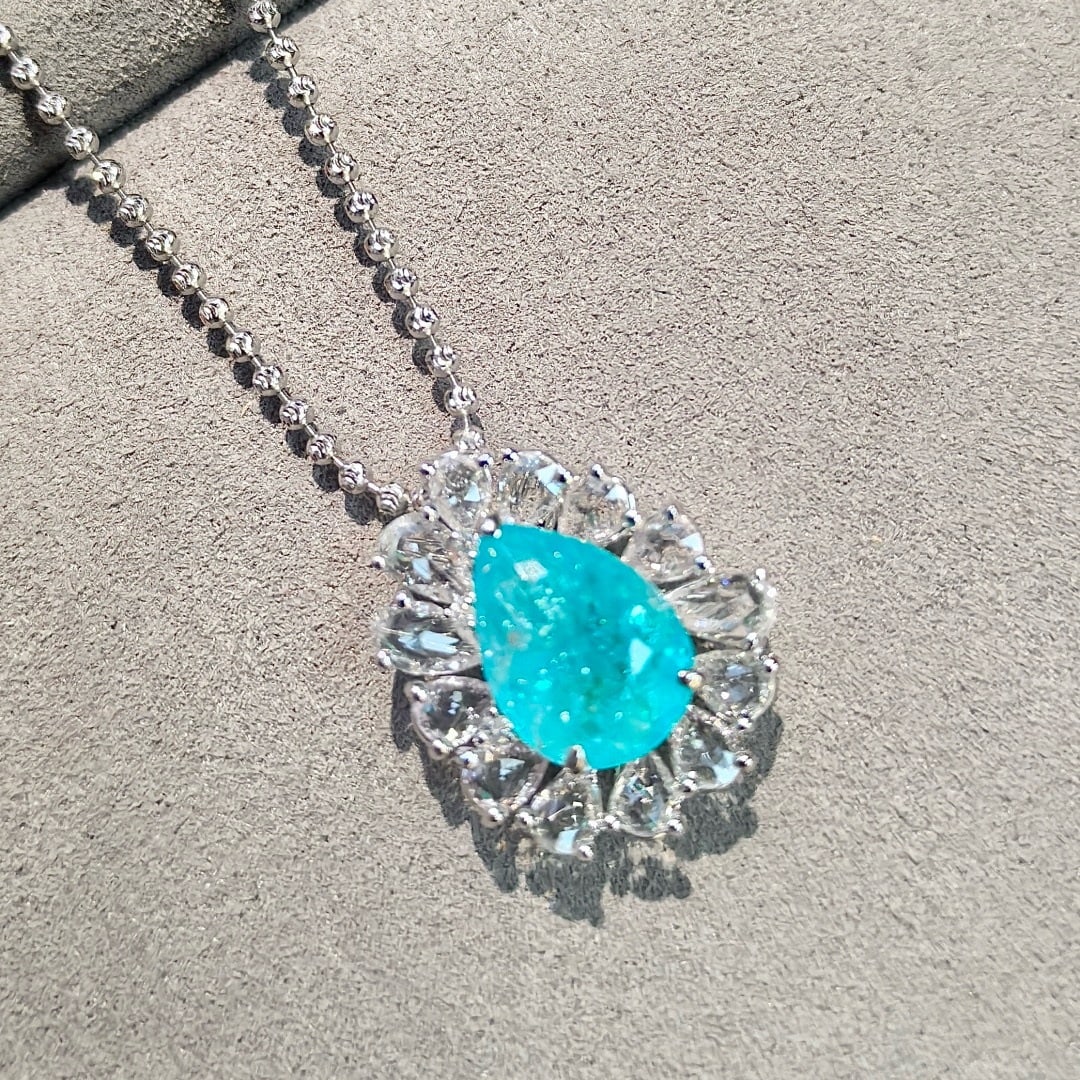 14k Gold 4.54 Ctw Natural Paraiba Tourmaline & Sapphire Pendant( Without Chain ): Ref:231170251 // gold content:14k gold // main gemstone:paraiba tourmaline // shape:pear // carat weight:3. 13ct // color:neon blue // treatment:natural // // adjacent gemstone 2 : sapphire //