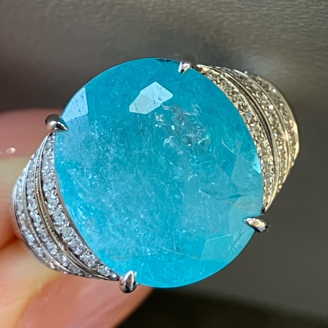 14k Gold 7.71 Ctw Natural Paraiba Tourmaline & Diamond Ring: Ref:231170346 // gold content:14k gold // ring size:7. 25us // // main gemstone:paraiba tourmaline // shape:oval // carat weight:7. 40ct // color:neon blue // treatment:natural // // adjacent gemstone