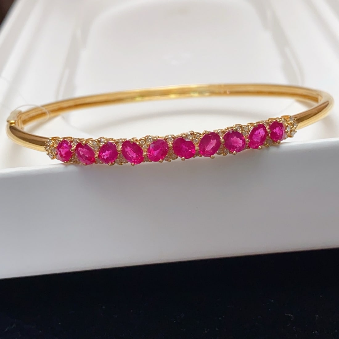 14k Gold 3.35 Ct Natural Ruby & Diamond Bangle: Ref:231170362 // gold content:14k gold // main gemstone:ruby // shape:oval // carat weight:3. 35ct // color:red // treatment:natural // // adjacent gemstone 2 : diamond // number of stones:48 // shape