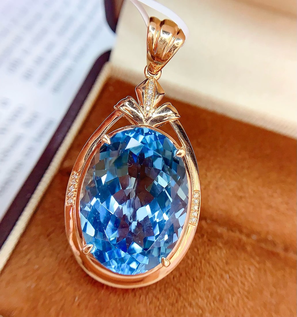 14k Gold 22.55 Ct Natural Topaz & Diamond Pendant( Without Chain ): Ref:231172420 // gold content:14k gold // main gemstone:topaz // shape:oval // carat weight:22. 55ct // color:blue // treatment:natural // // adjacent gemstone 2 : diamond // number of stones:16 //