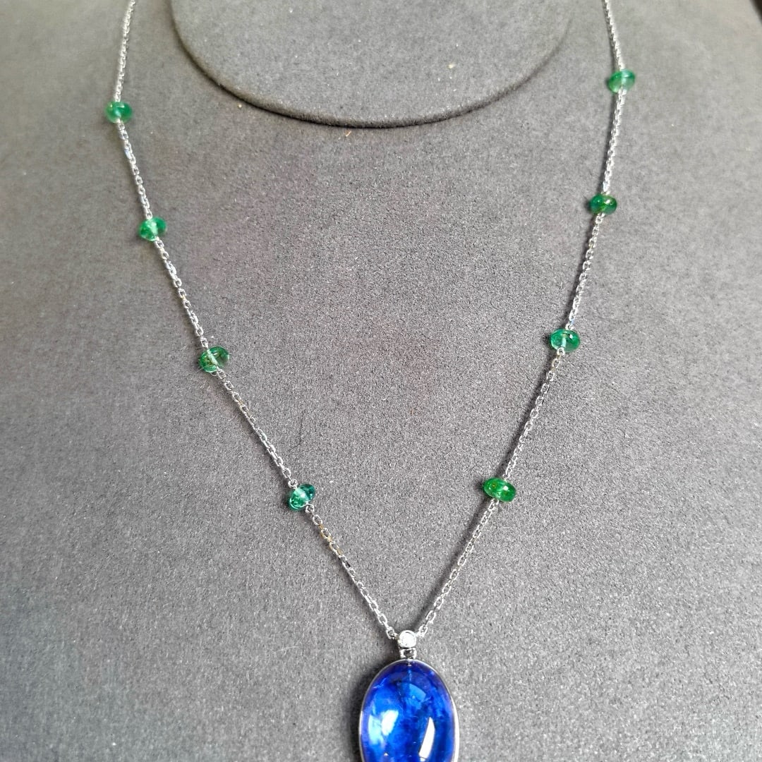 14k Gold 16.70 Ctw Natural Tanzanite & Emerald Necklace: Ref:231069156 // gold content:14k gold // main gemstone:tanzanite // shape:oval // carat weight:13. 85ct // color:blue // treatment:natural // // adjacent gemstone 2 : emerald // shape:bead //