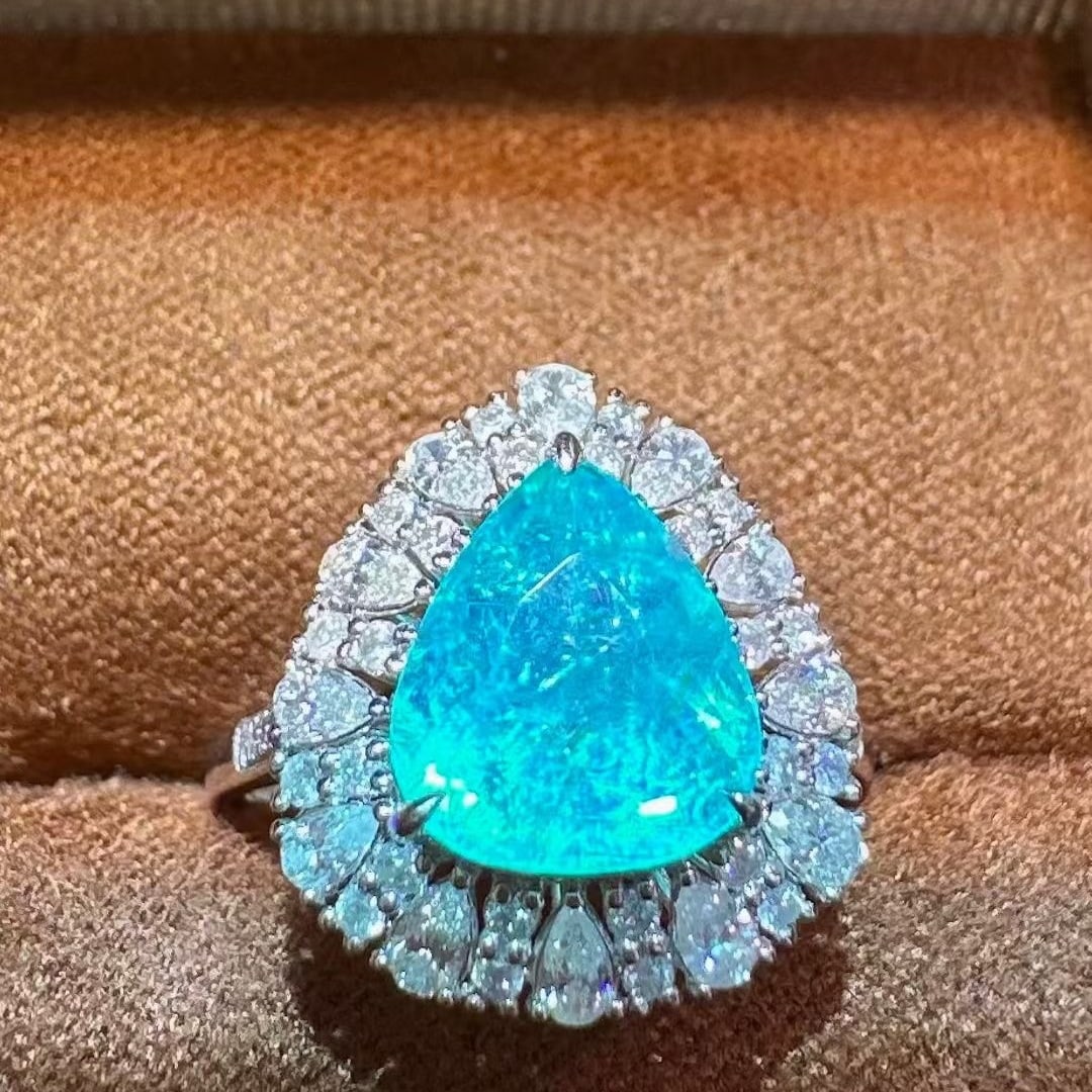 14k Gold 3.55 Ctw Natural Paraiba Tourmaline & Diamond Ring: Ref:231069189 // gold content:14k gold // ring size:7. 25us // // main gemstone:paraiba tourmaline // shape:pear // carat weight:2. 82ct // color:blue // treatment:natural // // adjacent gemstone