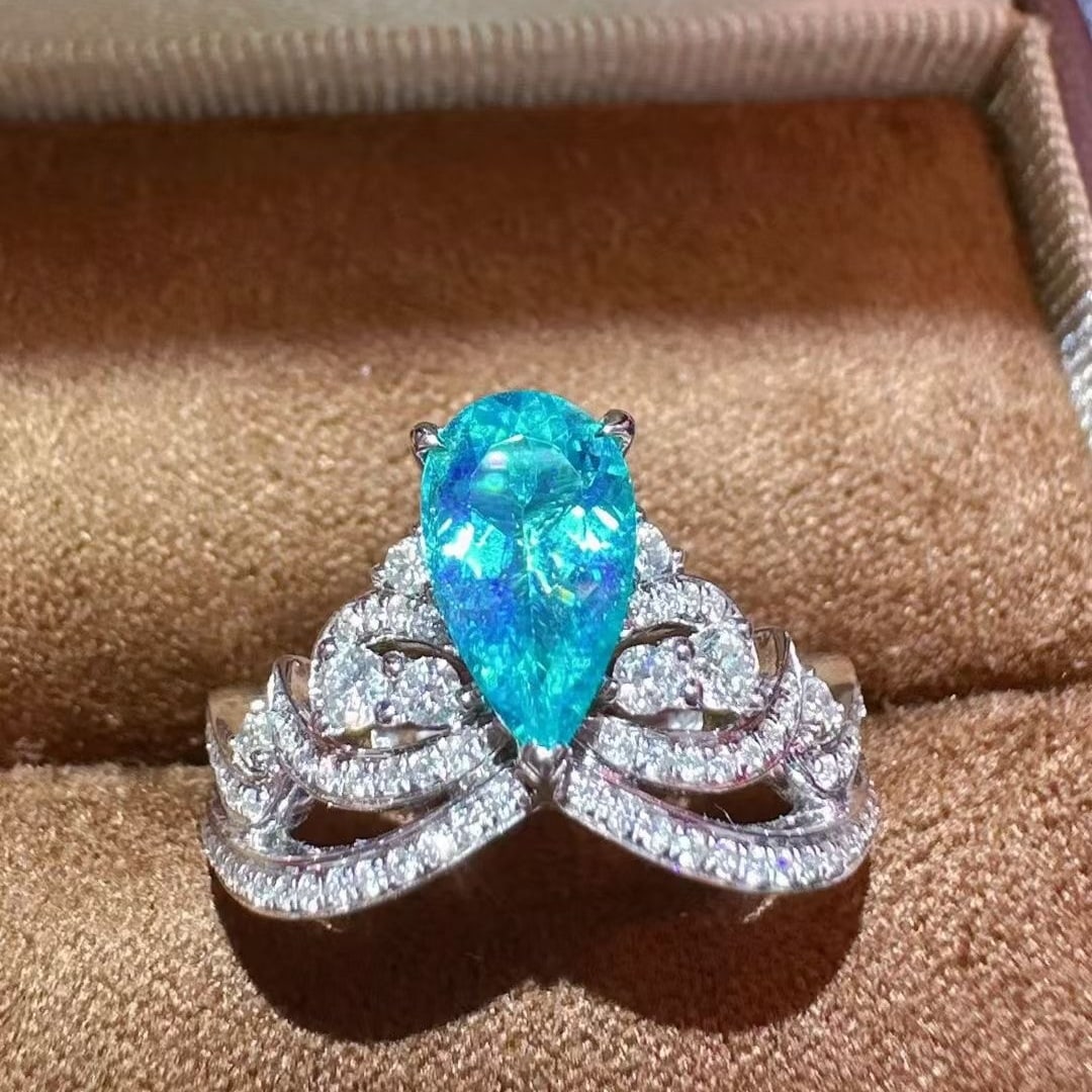 14k Gold 1.30 Ctw Natural Paraiba Tourmaline & Diamond Ring: Ref:231073243 // gold content:14k gold // ring size:7. 25us // // main gemstone:paraiba tourmaline // shape:pear // carat weight:0. 86ct // color:blue // treatment:natural // // adjacent gemstone