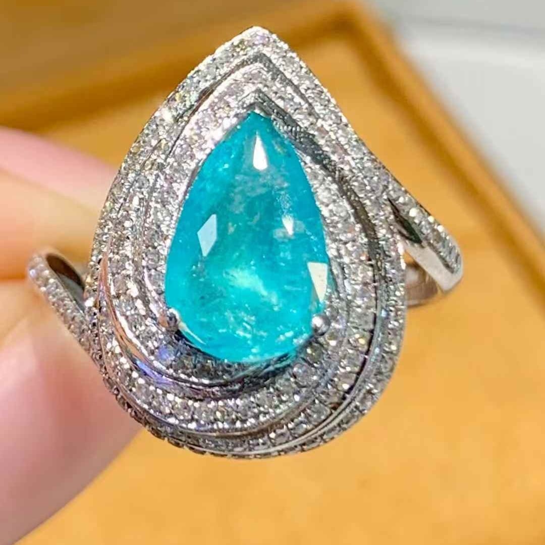 14k Gold 1.3 Ct Natural Paraiba Tourmaline & Diamond Ring: Ref:231075048 // gold content:14k gold // ring size:7. 25us // // main gemstone:paraiba tourmaline // shape:pear // carat weight:1. 3ct // color:blue // treatment:natural // // adjacent gemstone 2 : d