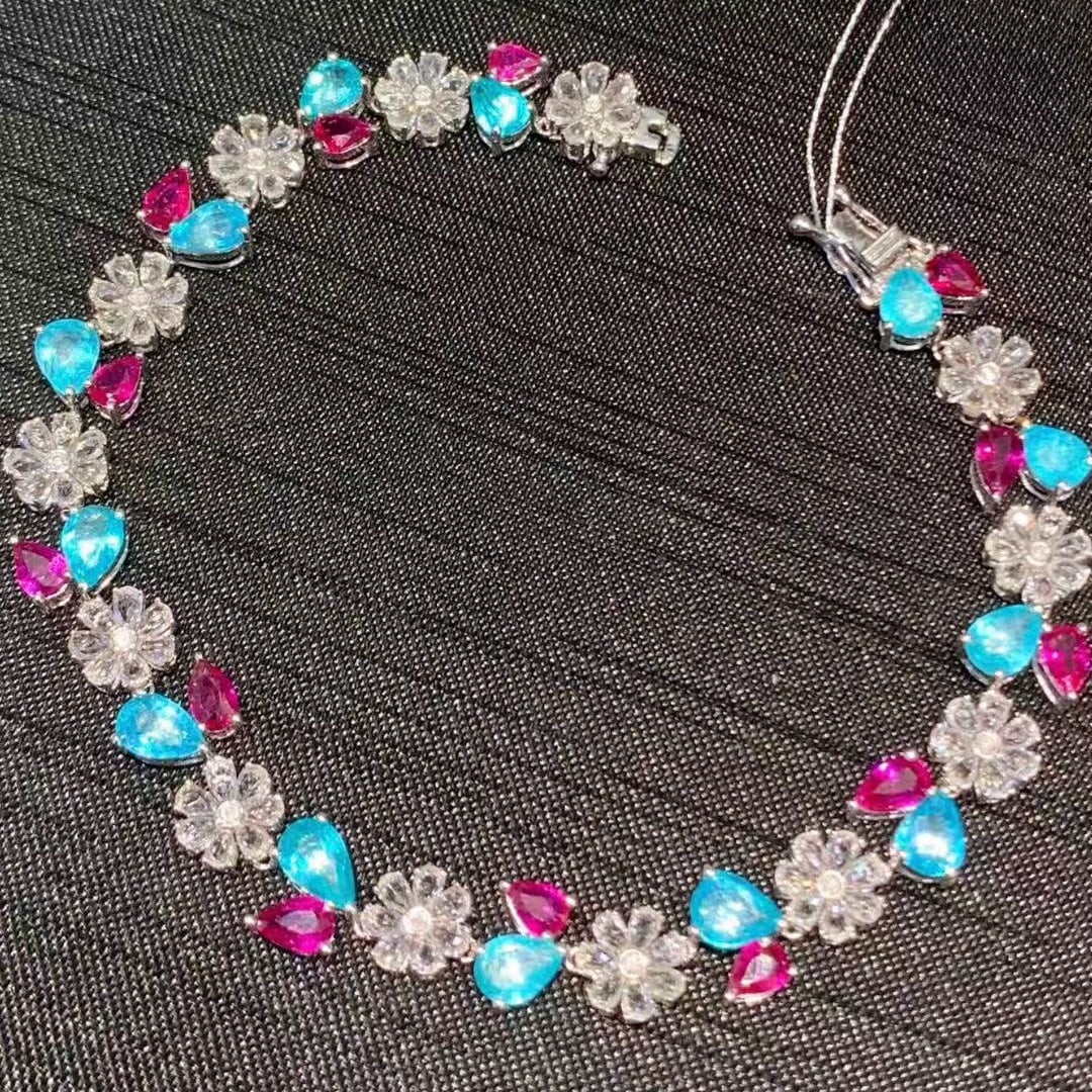 14k Gold 9.3 Ct Natural Paraiba Tourmaline & Ruby Bracelet: Ref:231079085 // gold content:14k gold // main gemstone:paraiba tourmaline & ruby // shape:pear // carat weight:9. 3ct // color:blue & red // treatment:natural // // adjacent gemstone 2 : sapphire //