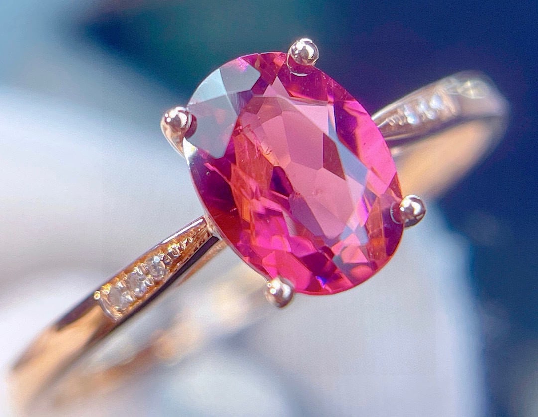 14k Gold 1.25 Ct Natural Tourmaline & Diamond Ring: Ref:231082433 // gold content:14k gold // ring size:7. 25us // // main gemstone:tourmaline // shape:oval // carat weight:1. 25ct // color:red // treatment:natural // // adjacent gemstone 2 : diamond /