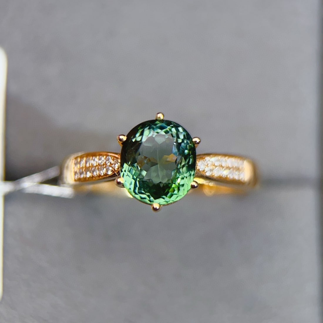 14K GOLD 2.03 CTW NATURAL TOURMALINE & DIAMOND RING: Ref:231083206 // Gold Content:14K Gold // Ring Size:7.25US // // Main Gemstone:Tourmaline // Shape:Oval // Carat Weight:1.95ct // Color:Green // Treatment:Natural // // Adjacent Gemstone 2 : Diamond /