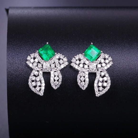 14K GOLD 1.20 CTW VIVID GREEN NATURAL EMERALD & DIAMOND EARRINGS: Ref:231084012 // Gold Content:14K Gold // Main Gemstone:Emerald // Shape:Octagonal // Carat Weight:0.68ct // Color:Vivid Green // Treatment:Natural // // Adjacent Gemstone 2 : Diamond //