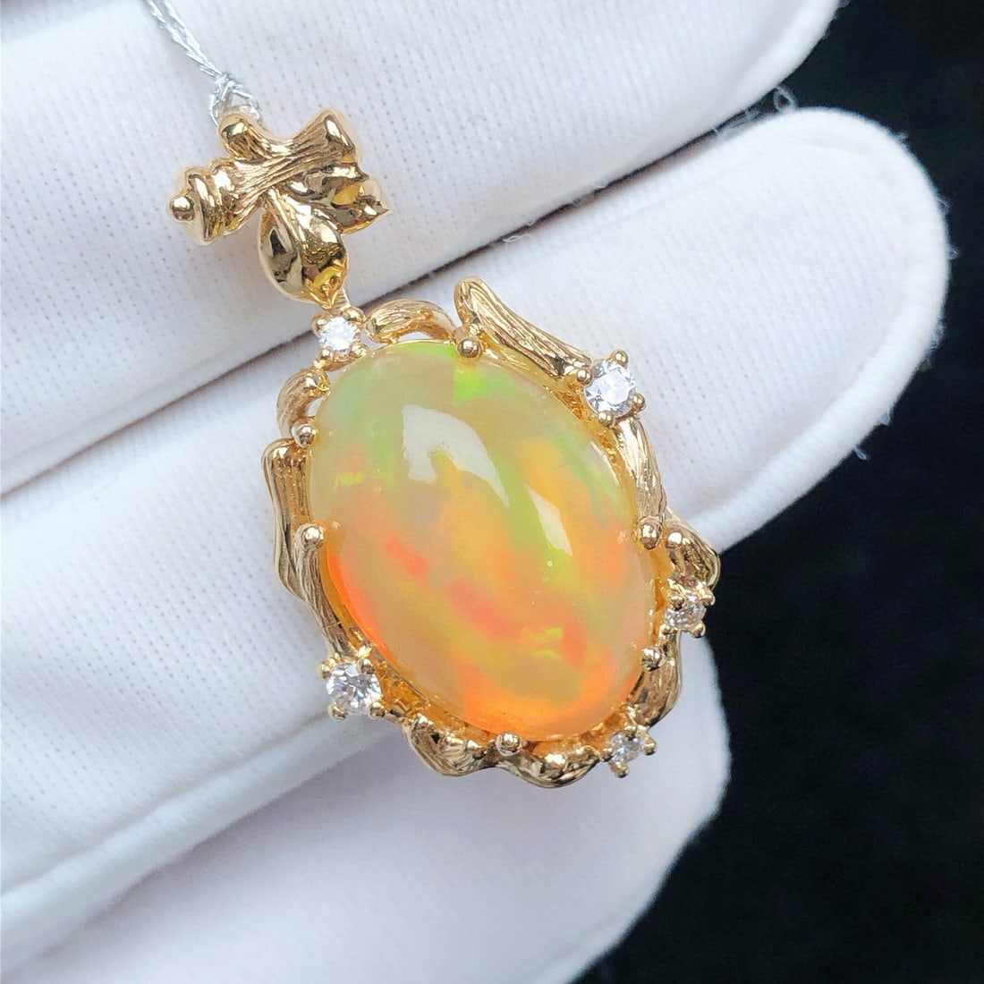 14K GOLD 4.12 CTW NATURAL OPAL & DIAMOND PENDANT( WITHOUT CHAIN ): Ref:231084037 // Gold Content:14K Gold // Main Gemstone:Opal // Shape:Oval // Carat Weight:4.0ct // Color:Color // Treatment:Natural // // Adjacent Gemstone 2 : Diamond // Shape:Round // Carat Weight: