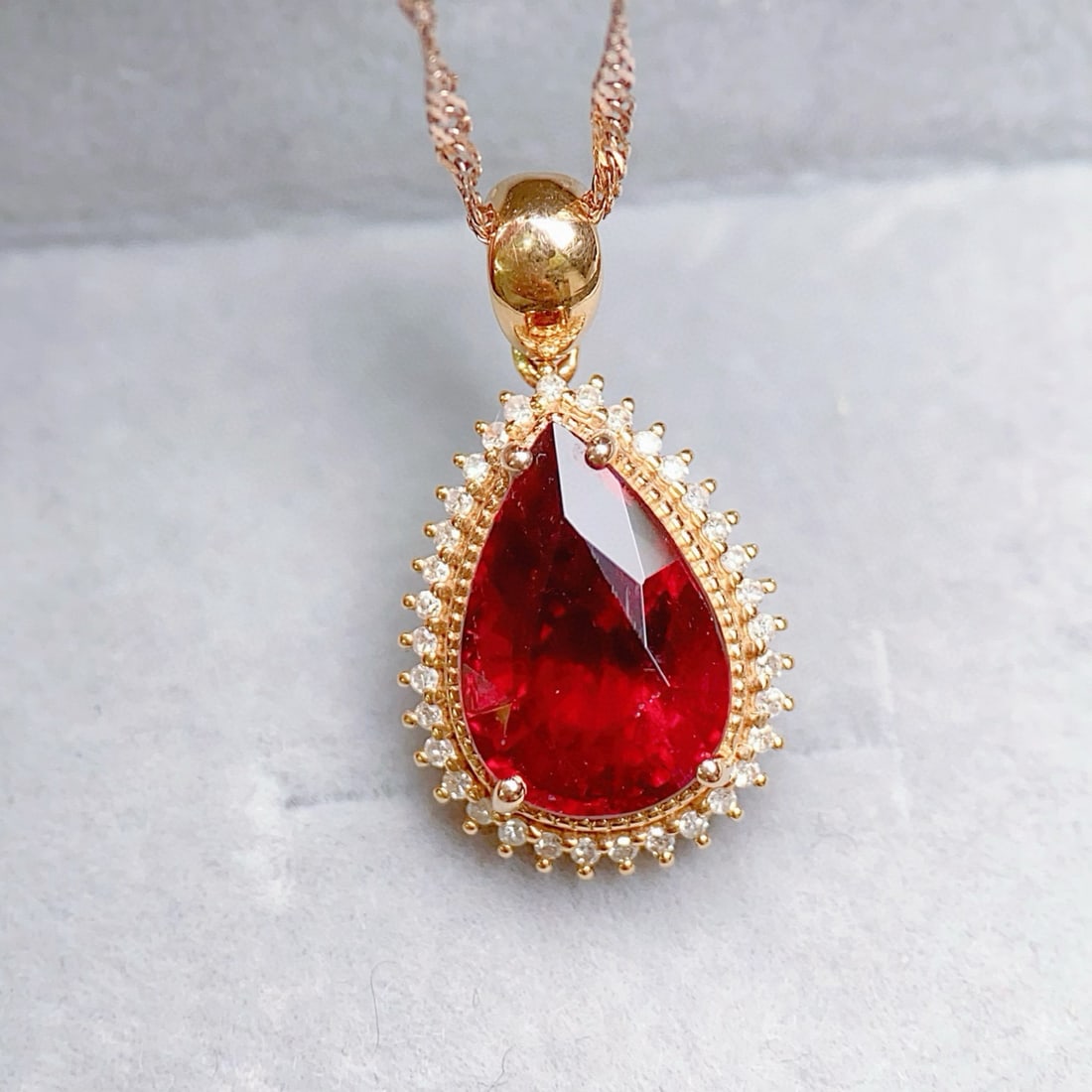 14K GOLD 4.52 CTW NATURAL TOURMALINE & DIAMOND PENDANT( WITHOUT CHAIN ): Ref:231084131 // Gold Content:14K Gold // Main Gemstone:Tourmaline // Shape:Pear // Carat Weight:4.35ct // Color:Red // Treatment:Natural // // Adjacent Gemstone 2 : Diamond // Number of stones:34 //