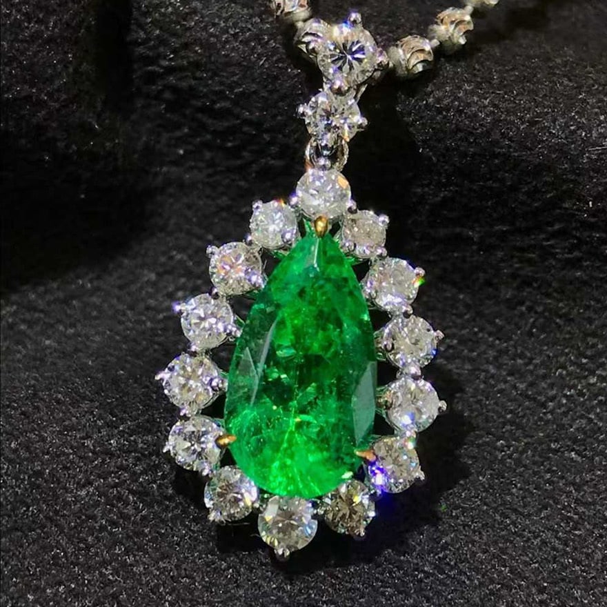 14K GOLD 1.76 CTW VIVID GREEN NATURAL EMERALD & DIAMOND PENDANT( WITHOUT CHAIN ): Ref:231084389 // Gold Content:14K Gold // Main Gemstone:Emerald // Shape:Pear // Carat Weight:1.22ct // Color:Vivid Green // Treatment:Natural // // Adjacent Gemstone 2 : Diamond // Shape:Round // Car