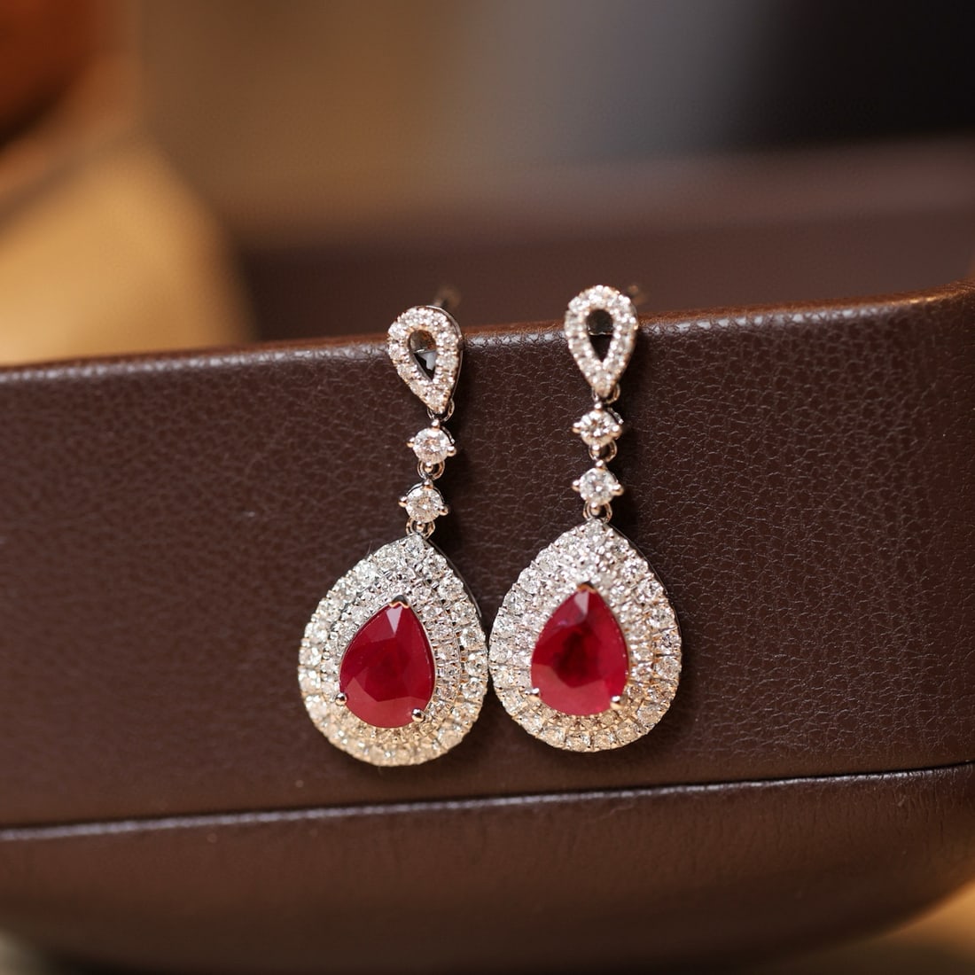 14k Gold 2.96 Ctw Vivid Red Natural Ruby & Diamond Earrings: Ref:231086033 // gold content:14k gold // main gemstone:ruby // shape:pear // carat weight:2. 07ct // color:vivid red // treatment:natural // // adjacent gemstone 2 : diamond // shape:round //