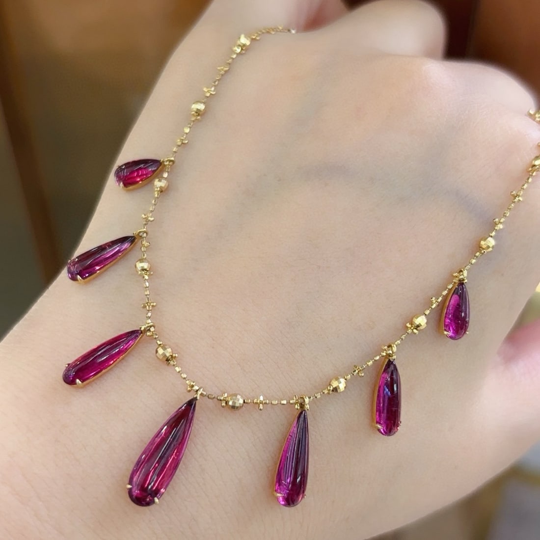 14k Gold 8 Ct Natural Tourmaline Necklace: Ref:231089084 // gold content:14k gold // main gemstone:tourmaline // shape:pear // carat weight:8ct // color:red // treatment:natural // Low Estimate: 4800Condition: NewHigh Estimate: 7300