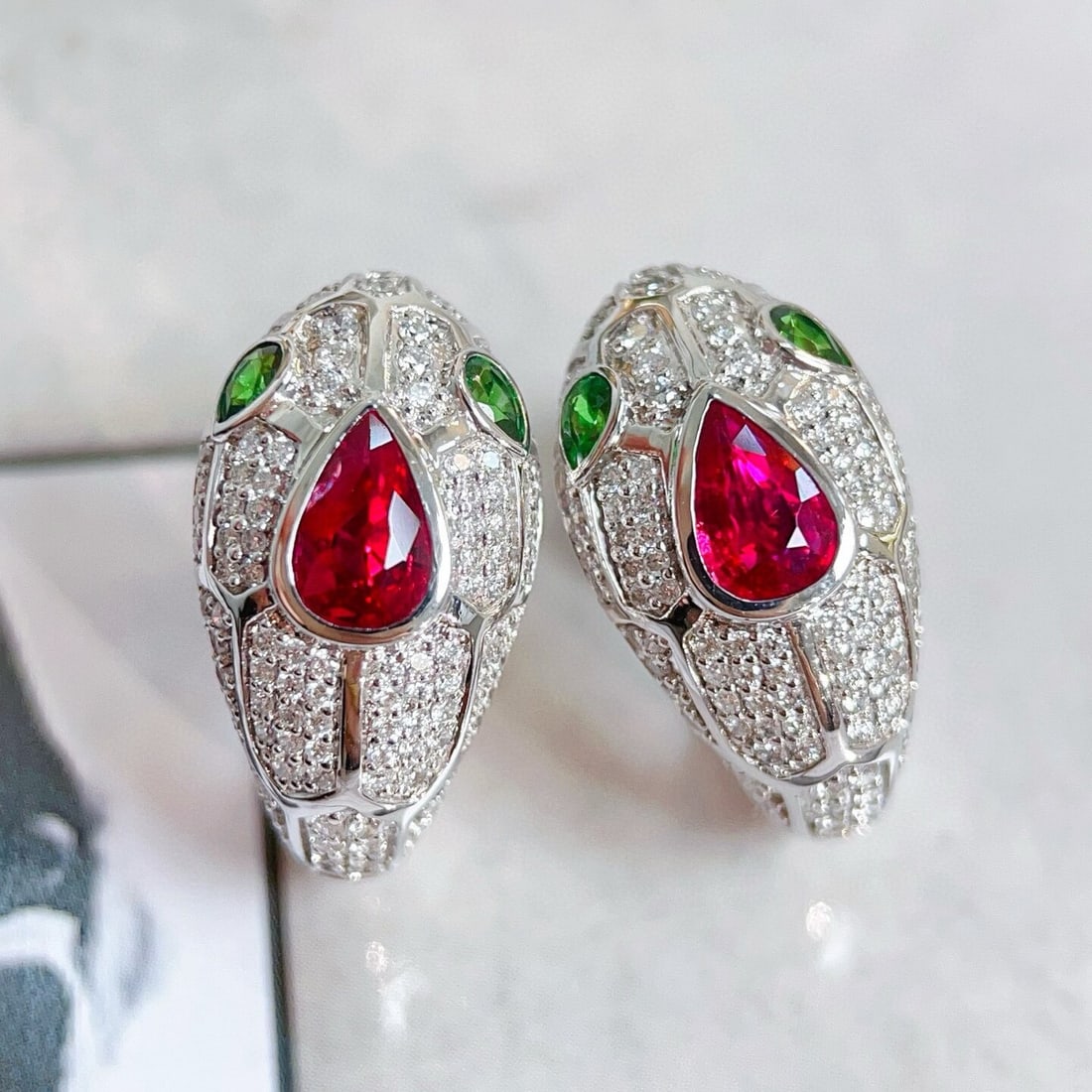 14k Gold 1.71 Ctw Natural Ruby & Diamond Earrings: Ref:230944001 // gold content:14k gold // main gemstone:ruby // shape:pear // carat weight:0. 95ct // color:red // treatment:natural // // adjacent gemstone 2 : diamond // shape:round // carat