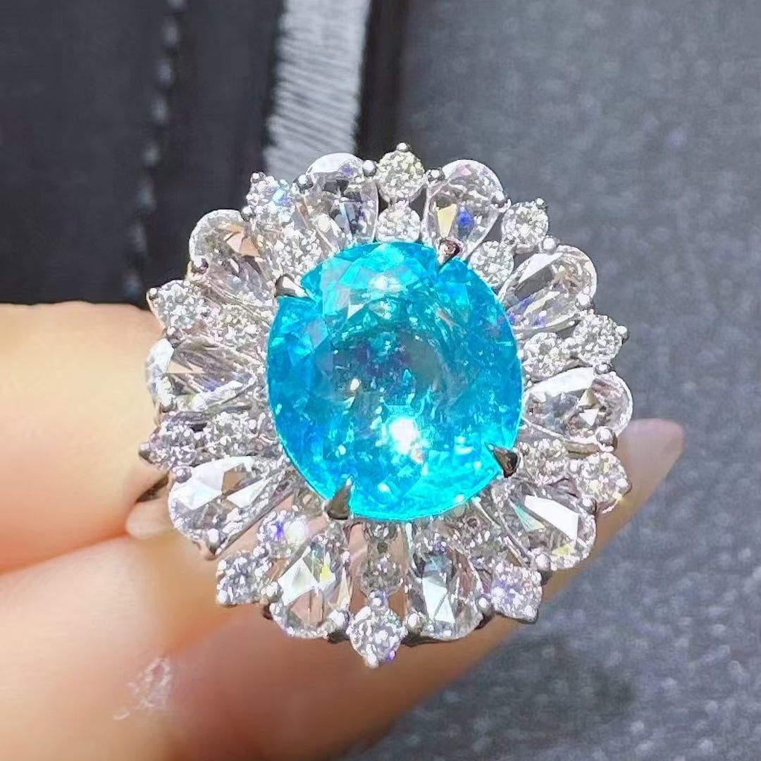 14k Gold 3.28 Ctw Natural Paraiba Tourmaline & Diamond Ring: Ref:230945010 // gold content:14k gold // ring size:7. 25us // // main gemstone:paraiba tourmaline // shape:oval // carat weight:2. 35ct // color:neon blue // treatment:natural // // adjacent gemstone
