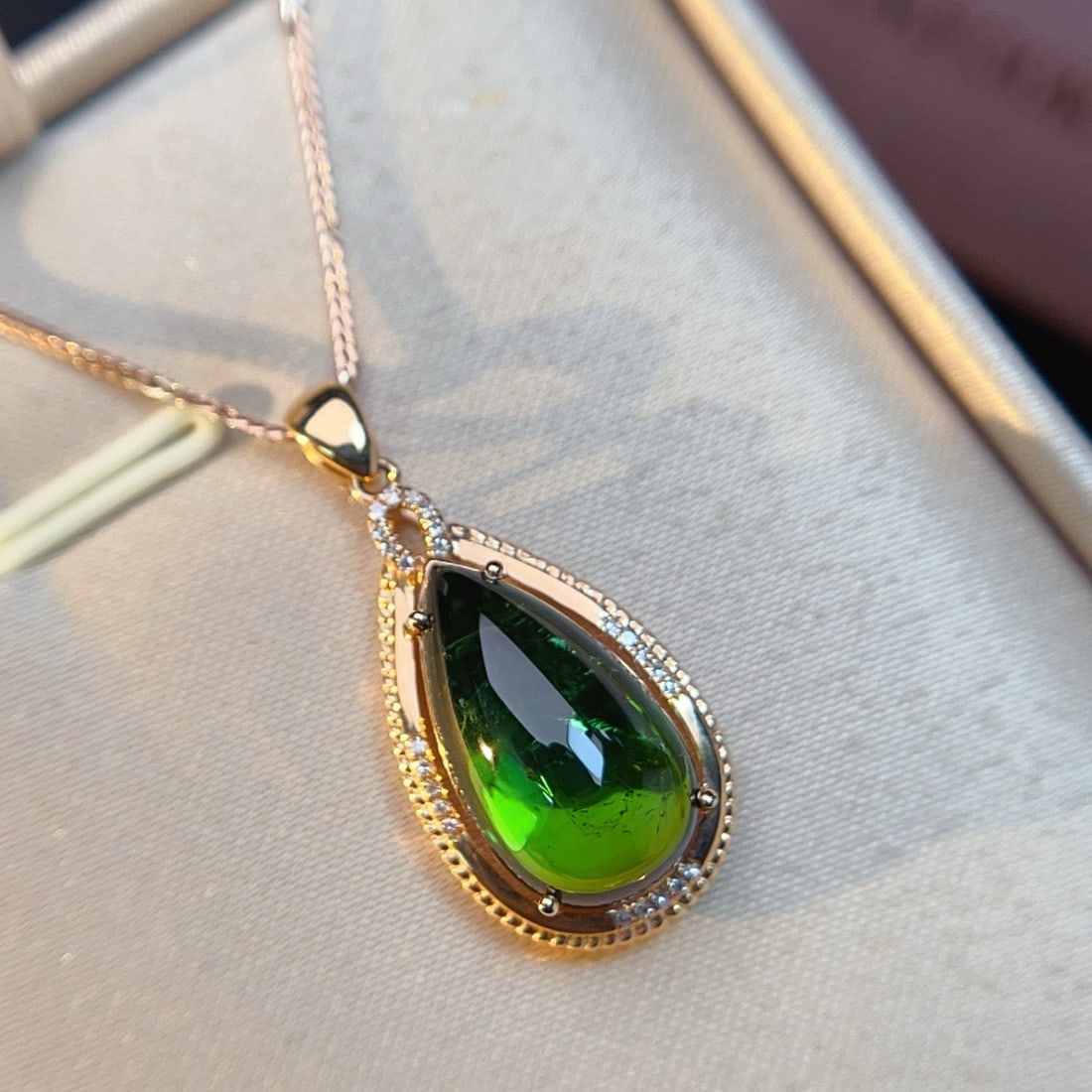 14k Gold 8.30 Ctw Natural Tourmaline & Diamond Pendant( Without Chain ): Ref:231178386 // gold content:14k gold // main gemstone:tourmaline // shape:pear // carat weight:8. 23ct // color:green // treatment:natural // // adjacent gemstone 2 : diamond // number of stones:24