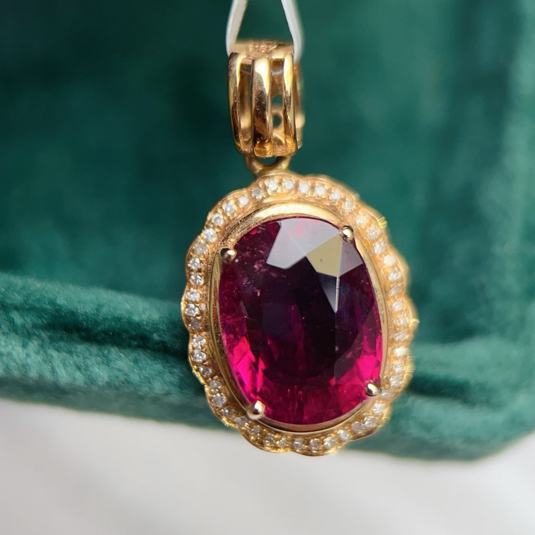 14k Gold 5.34 Ctw Natural Tourmaline & Diamond Pendant( Without Chain ): Ref:231180198 // gold content:14k gold // main gemstone:tourmaline // shape:oval // carat weight:5. 2ct // color:red // treatment:natural // // adjacent gemstone 2 : diamond // number of stones:47 //