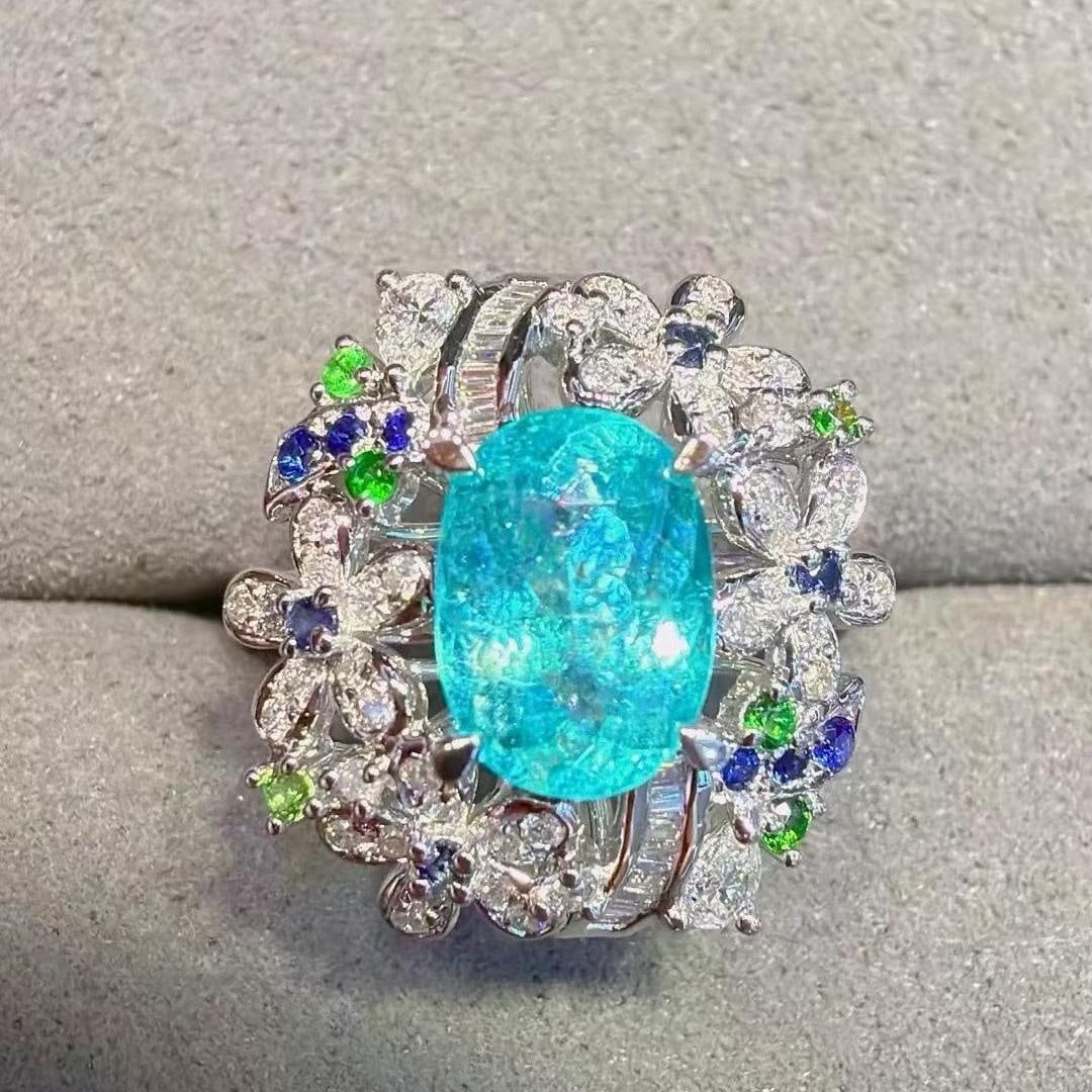 14k Gold 1.94 Ctw Natural Paraiba Tourmaline & Diamond Ring: Ref:231181114 // gold content:14k gold // ring size:7. 25us // // main gemstone:paraiba tourmaline // shape:oval // carat weight:1. 58ct // color:neon blue // treatment:natural // // adjacent