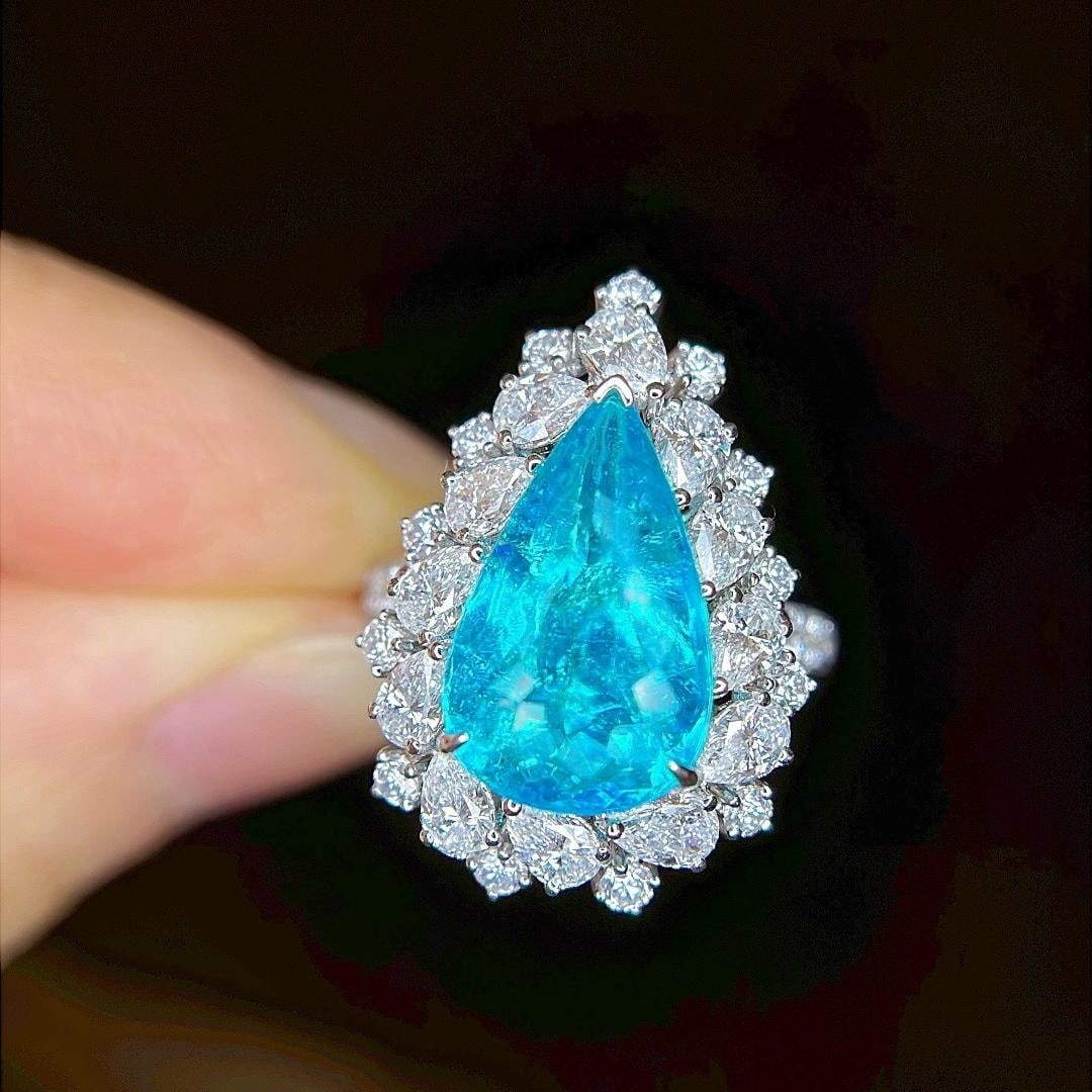14k Gold 7.2 Ctw Natural Paraiba Tourmaline & Diamond Ring: Ref:231182148 // gold content:14k gold // ring size:7. 25us // // main gemstone:paraiba tourmaline // shape:pear // carat weight:5ct // color:blue // treatment:natural // // adjacent gemstone 2 : diam