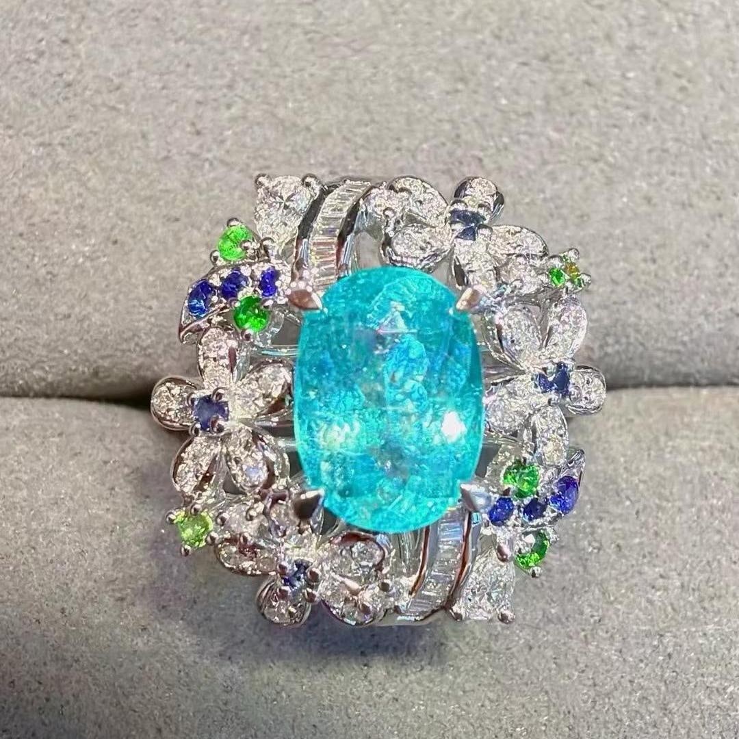 14k Gold 1.94 Ctw Natural Paraiba Tourmaline & Diamond Ring: Ref:231183019 // gold content:14k gold // ring size:7. 25us // // main gemstone:paraiba tourmaline // shape:oval // carat weight:1. 58ct // color:neon blue // treatment:natural // // adjacent