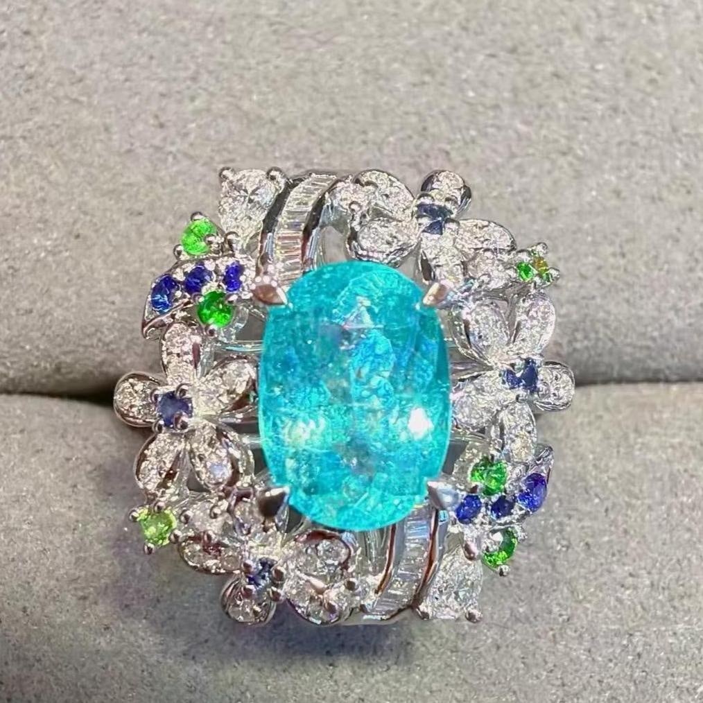 14k Gold 1.94 Ctw Natural Paraiba Tourmaline & Diamond Ring: Ref:231185061 // gold content:14k gold // ring size:7. 25us // // main gemstone:paraiba tourmaline // shape:oval // carat weight:1. 58ct // color:neon blue // treatment:natural // // adjacent gemstone