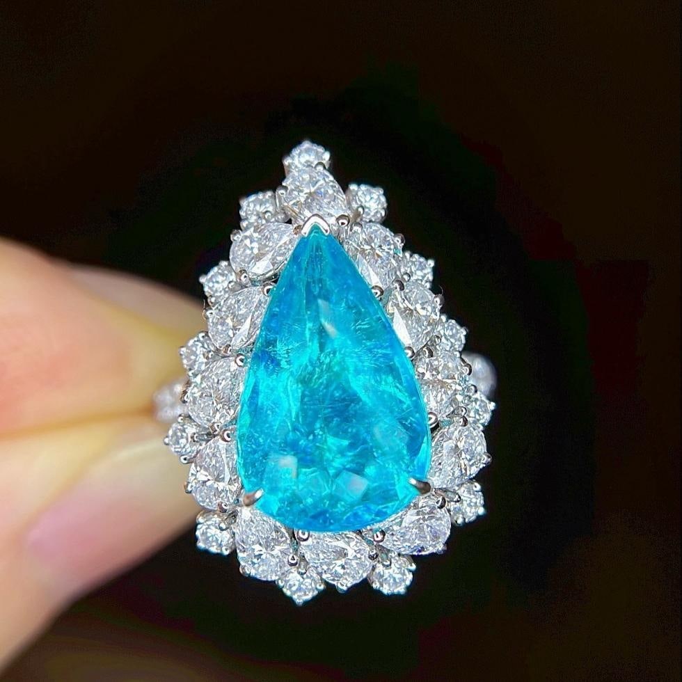 14k Gold 7.20 Ctw Natural Paraiba Tourmaline & Diamond Ring: Ref:231185067 // gold content:14k gold // ring size:7. 25us // // main gemstone:paraiba tourmaline // shape:pear // carat weight:5. 00ct // color:neon blue // treatment:natural // // adjacent gemstone