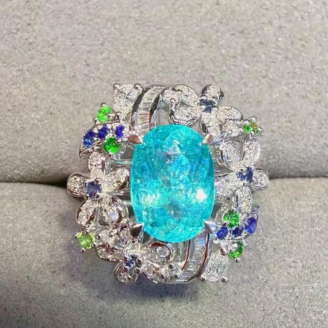 14k Gold 1.94 Ctw Natural Paraiba Tourmaline & Diamond Ring: Ref:231187173 // gold content:14k gold // ring size:7. 25us // // main gemstone:paraiba tourmaline // shape:oval // carat weight:1. 58ct // color:neon blue // treatment:natural // // adjacent