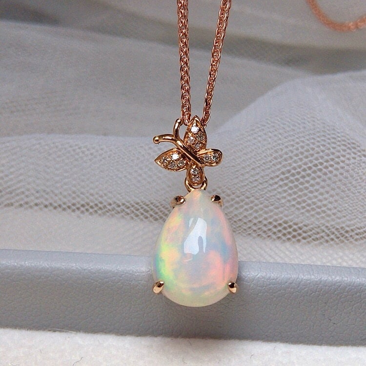 14k Gold 2.70 Ct Natural Opal & Diamond Pendant( Without Chain ): Ref:231190414 // gold content:14k gold // main gemstone:opal // shape:pear // carat weight:2. 70ct // color:white // treatment:natural // // adjacent gemstone 2 : diamond // number of stones:12 // sha