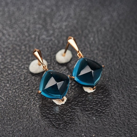 14k Gold 15 Ct Natural Topaz Earrings: Ref:231190429 // gold content:14k gold // main gemstone:topaz // shape:sugar-loaf // carat weight:15ct // color:blue // treatment:natural // Condition: New Low Estimate: 2400.00 High Estimate: 3600.00
