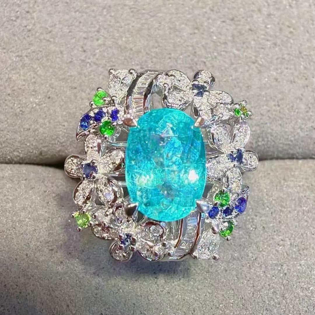 14k Gold 1.94 Ctw Natural Paraiba Tourmaline & Diamond Ring: Ref:231193160 // gold content:14k gold // ring size:7. 25us // // main gemstone:paraiba tourmaline // shape:oval // carat weight:1. 58ct // color:neon blue // treatment:natural // // adjacent