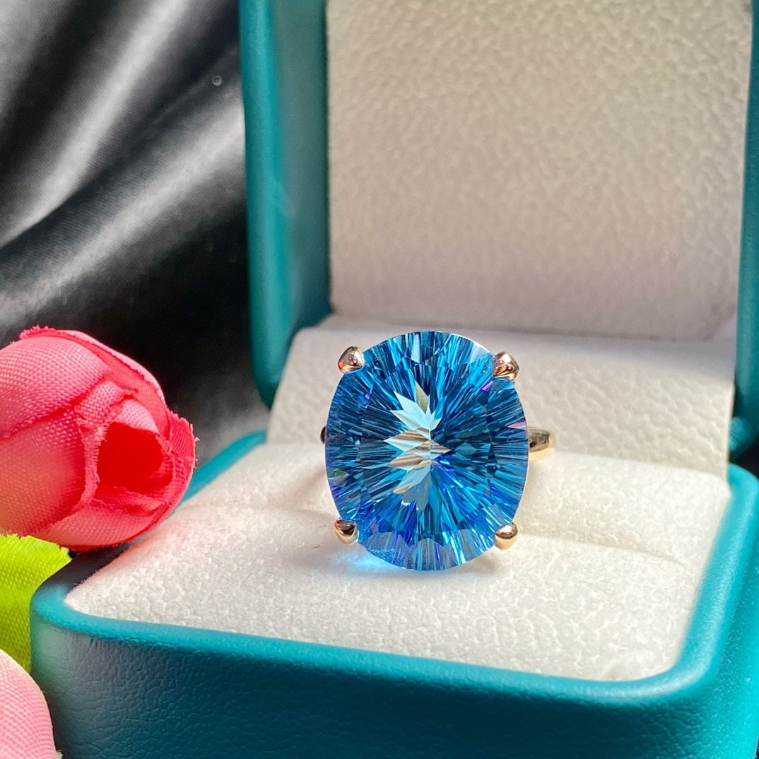14k Gold 19.4 Ct Natural Topaz Ring: Ref:231194220 // gold content:14k gold // ring size:7. 25us // // main gemstone:topaz // shape:oval // carat weight:19. 4ct // color:blue // treatment:natural // Condition: New Low Estimate: 2100.00