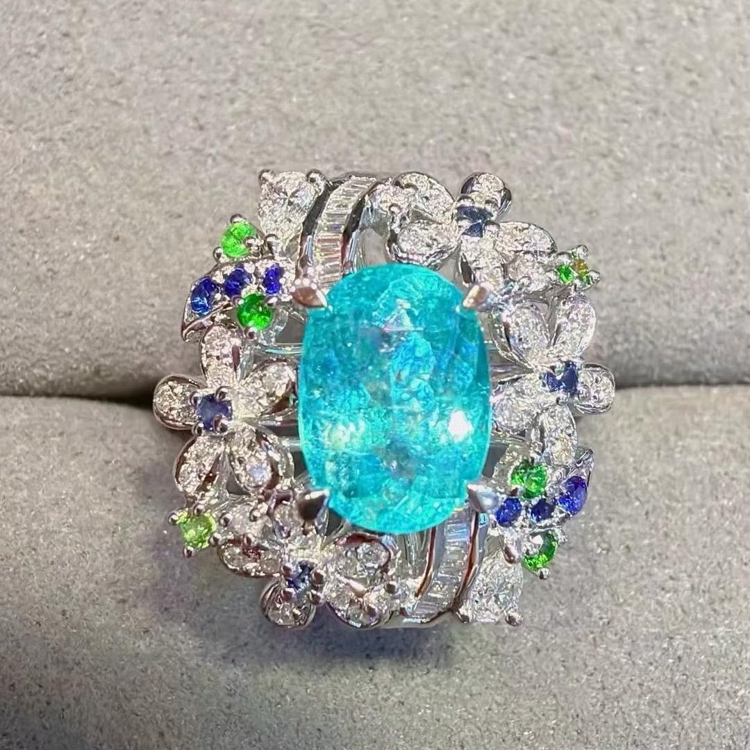 14k Gold 1.94 Ctw Natural Paraiba Tourmaline & Diamond Ring: Ref:231195196 // gold content:14k gold // ring size:7. 25us // // main gemstone:paraiba tourmaline // shape:oval // carat weight:1. 58ct // color:neon blue // treatment:natural // // adjacent gemstone