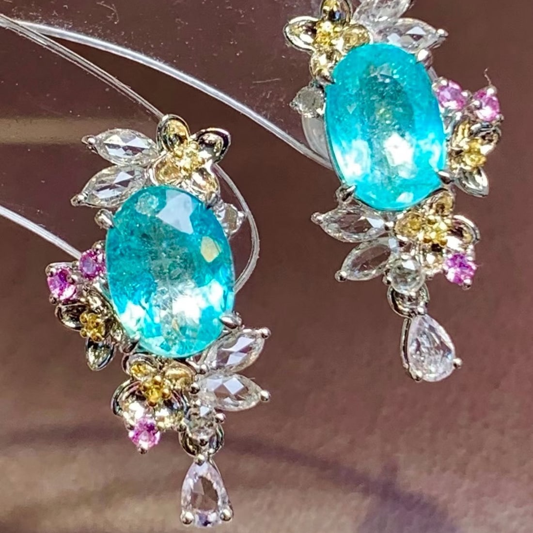 14k Gold 1.7 Ct Natural Paraiba Tourmaline & Diamond & Sapphire Earrings: Ref:231195235 // gold content:14k gold // main gemstone:paraiba tourmaline // shape:oval // carat weight:1. 7ct // color:blue // treatment:natural // // adjacent gemstone 2 : diamond // shape:round //