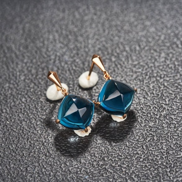 14k Gold 15 Ct Natural Topaz Earrings: Ref:231173207 // gold content:14k gold // main gemstone:topaz // shape:sugar-loaf // carat weight:15ct // color:blue // treatment:natural // Condition: New Low Estimate: 2200.00 High Estimate: 3300.00