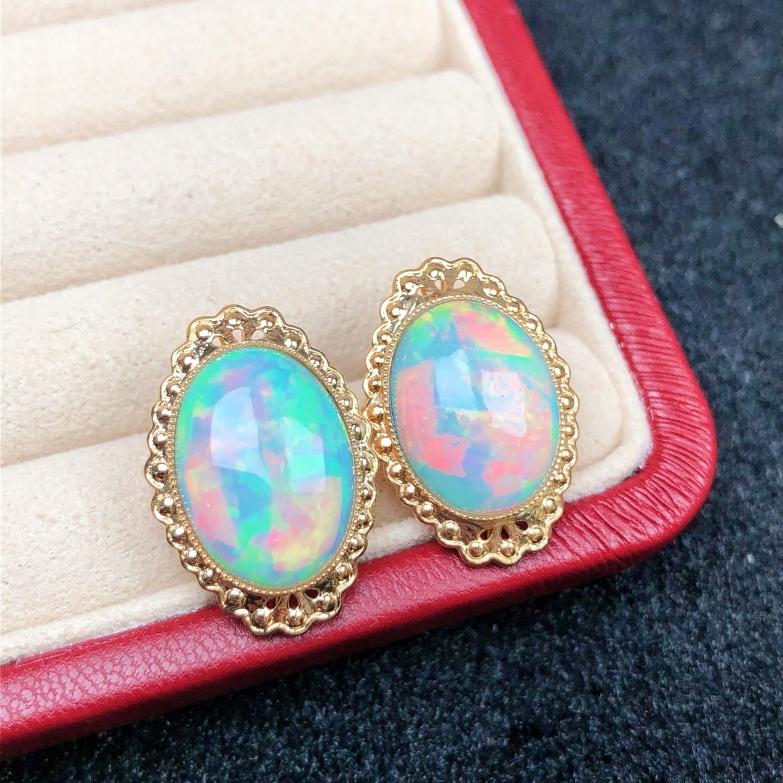 14k Gold 10.60 Ct Natural Opal Earrings: Ref:231174017 // gold content:14k gold // main gemstone:opal // shape:oval // carat weight:10. 60ct // color:color // treatment:natural // Condition: New Low Estimate: 5700.00 High Estimate: 8600.00