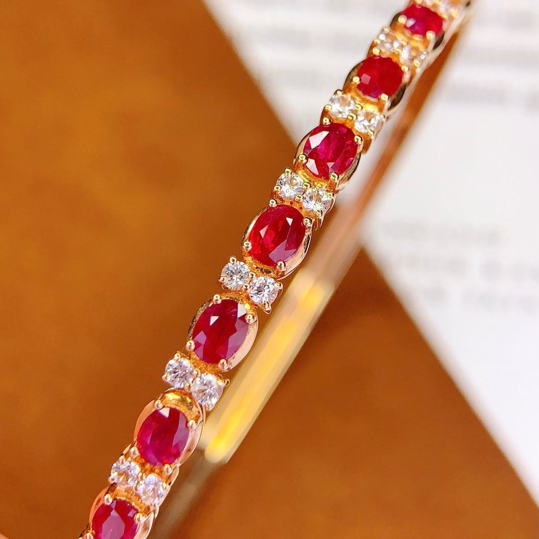 14k Gold 2.5 Ct Natural Ruby & Sapphire Bangle: Ref:231174322 // gold content:14k gold // main gemstone:ruby // shape:oval // carat weight:2. 5ct // color:red // treatment:natural // // adjacent gemstone 2 : sapphire // number of stones:18 // shape