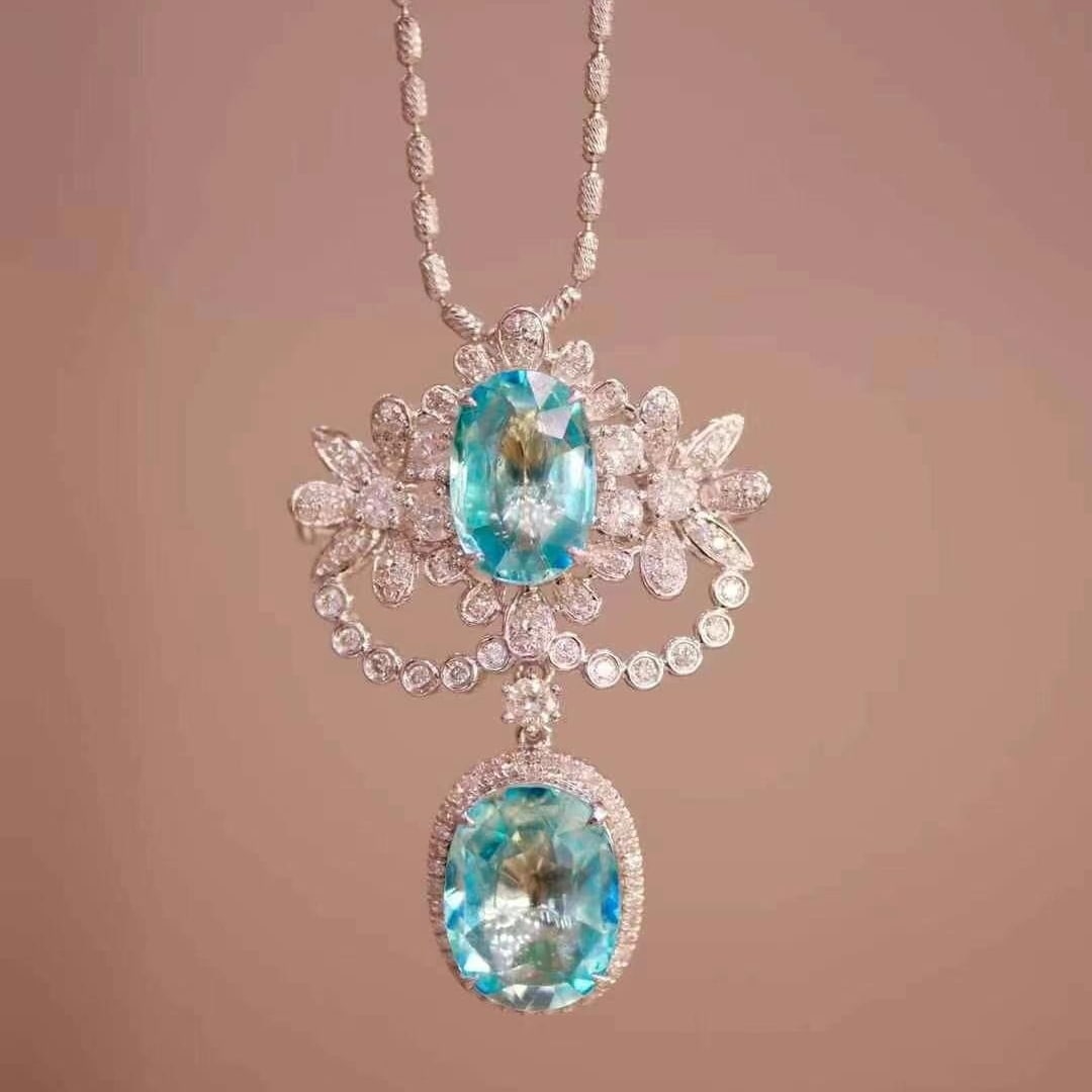 14k Gold 4.8 Ct Natural Paraiba Tourmaline & Diamond Brooch/pendant( Without Chain ): Ref:230949034 // gold content:14k gold // main gemstone:paraiba tourmaline // shape:oval // carat weight:4. 8ct // color:blue // treatment:natural // // adjacent gemstone 2 : diamond // shape:round //