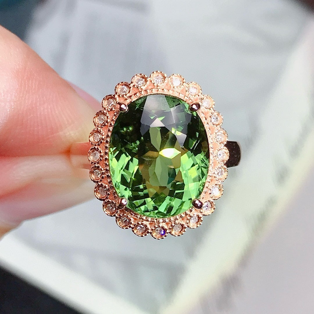 14k Gold 5.5 Ct Natural Tourmaline & Diamond Ring: Ref:230950204 // gold content:14k gold // ring size:7. 25us // // main gemstone:tourmaline // shape:oval // carat weight:5. 5ct // color:green // treatment:natural // // adjacent gemstone 2 : diamond