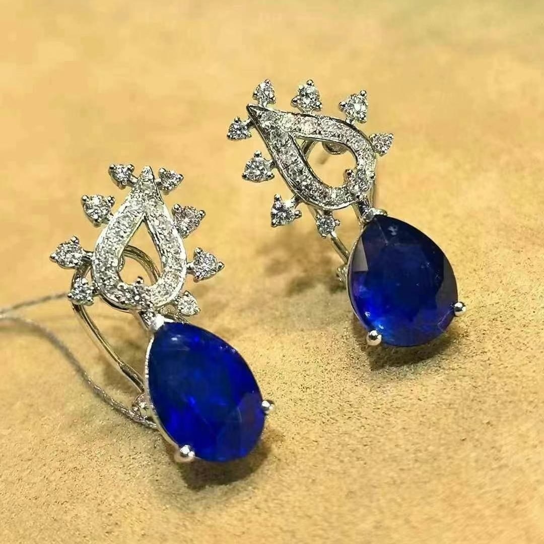 14k Gold 5.75 Ctw Vivid Blue Natural Sapphire & Diamond Earrings: Ref:230949105 // gold content:14k gold // main gemstone:sapphire // shape:pear // carat weight:5. 29ct // color:vivid blue // treatment:natural // // adjacent gemstone 2 : diamond // shape:round // ca