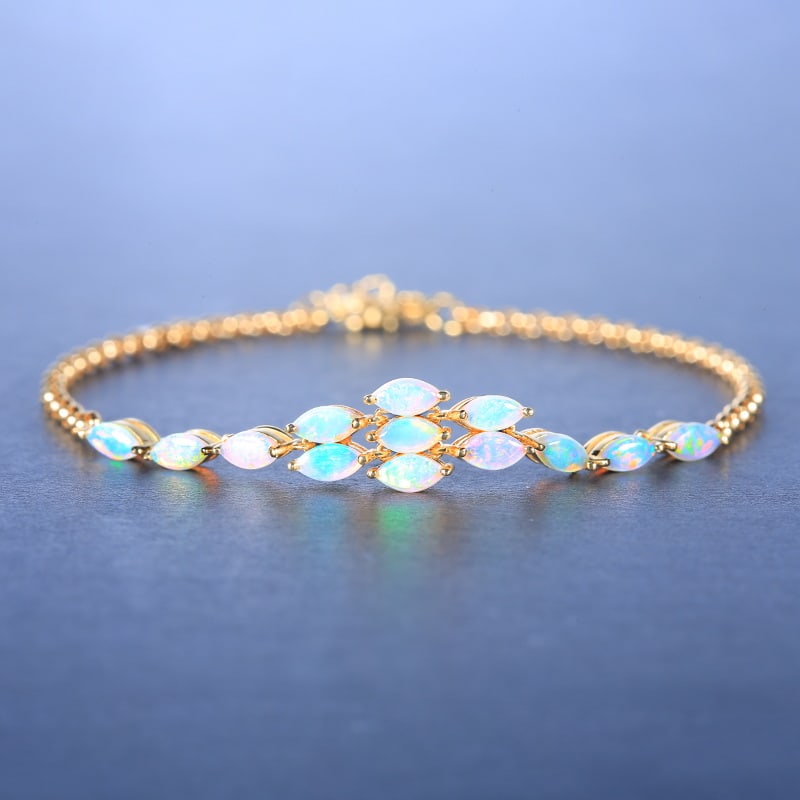 14k Gold 1.25 Ct Natural Opal Bracelet: Ref:230955005 // gold content:14k gold // main gemstone:opal // shape:marquise // carat weight:1. 25ct // color:white // treatment:natural // Condition: NewLow Estimate: 3500.00High Estimate: 5300.00