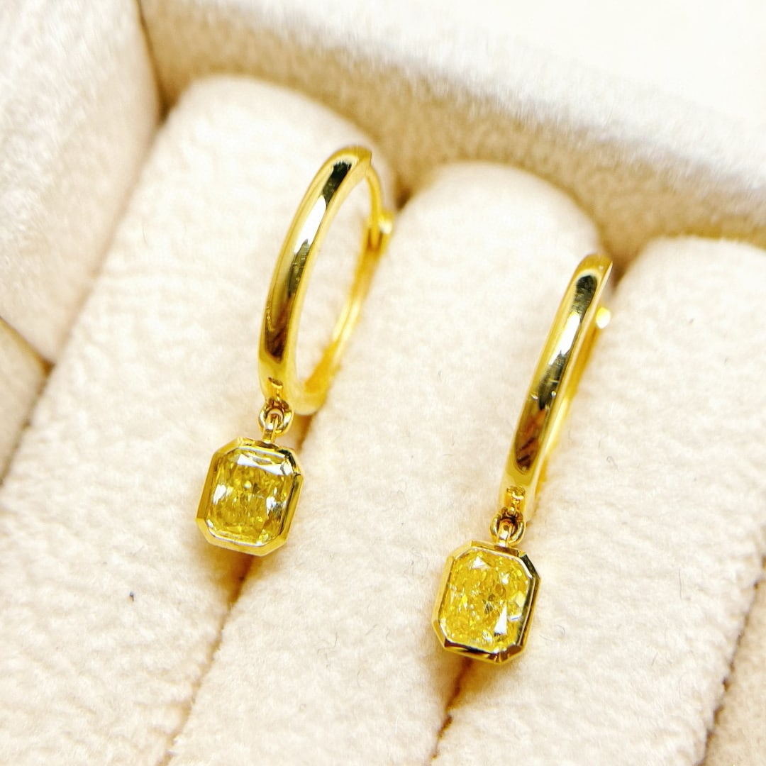 14k Gold 0.61 Ct Natural Yellow Diamond Earrings: Ref:230957022 // gold content:14k gold // main gemstone:yellow diamond // shape:radiant // carat weight:0. 61ct // color:yellow // treatment:natural // Condition: NewLow Estimate: 5500.00High